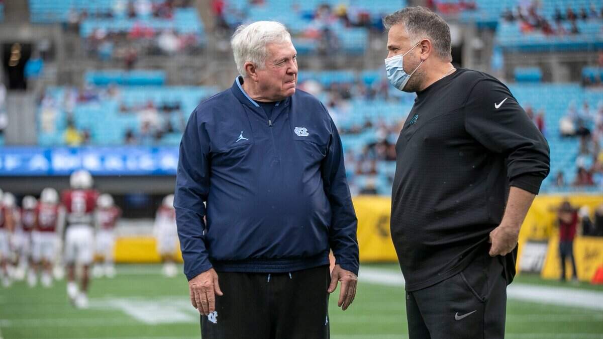 North Carolina coach Mack Brown talks with Carolina Panthers coach Matt Rhule prior to the Duke’s Mayo Bowl on Thursday, December 30, 2021 at Bank of America Stadium in Charlotte, N.C.