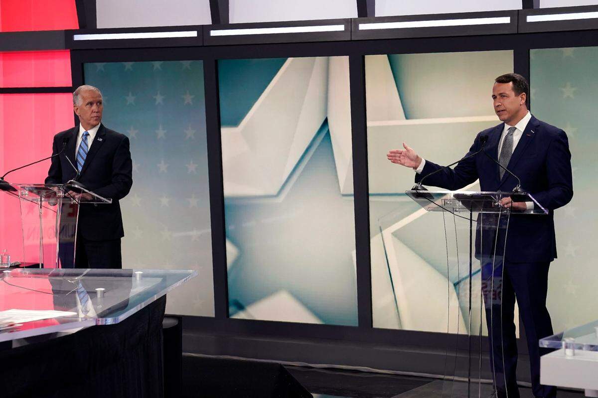 U.S. Sen. Thom Tillis, R-N.C. left, listens as Democratic challenger Cal Cunningham makes comments at right during a televised debate at WNCN-TV in Raleigh, N.C., Tuesday, Sept. 22, 2020.