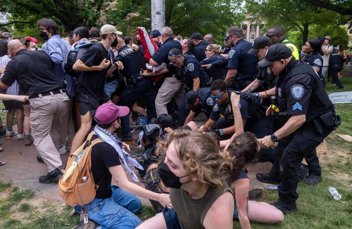 Pro-Palestinian demonstrators clash with police after replacing an American flag with a Palestinian flag Tuesday, April 30, 2024 at UNC-Chapel Hill. Police removed a “Gaza solidarity encampment” earlier Tuesday morning.