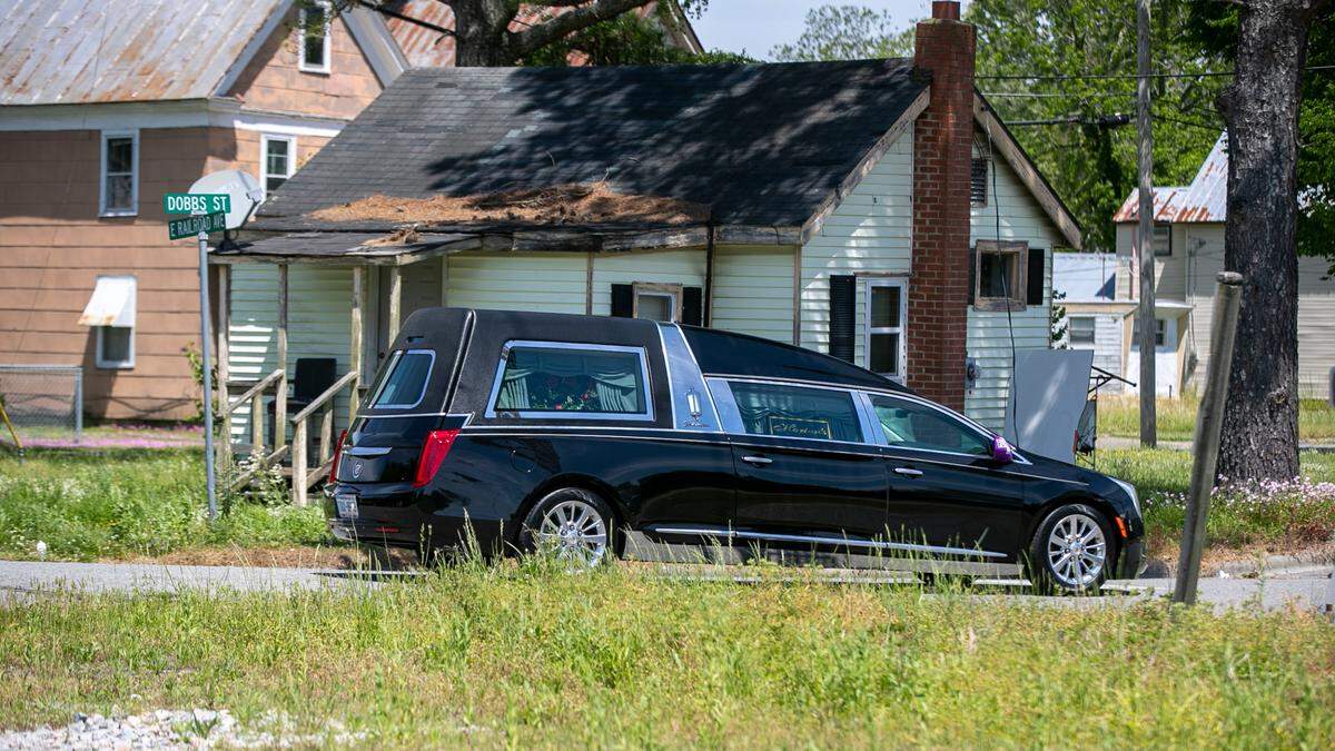 A hearse carrying the body of Andrew Brown Jr. leaves Horton’s Funeral Home and travels along Dobbs Street in Hertford, N.C. on the way to the second public viewing in Elizabeth City, N.C. on Sunday, May 2, 2021.