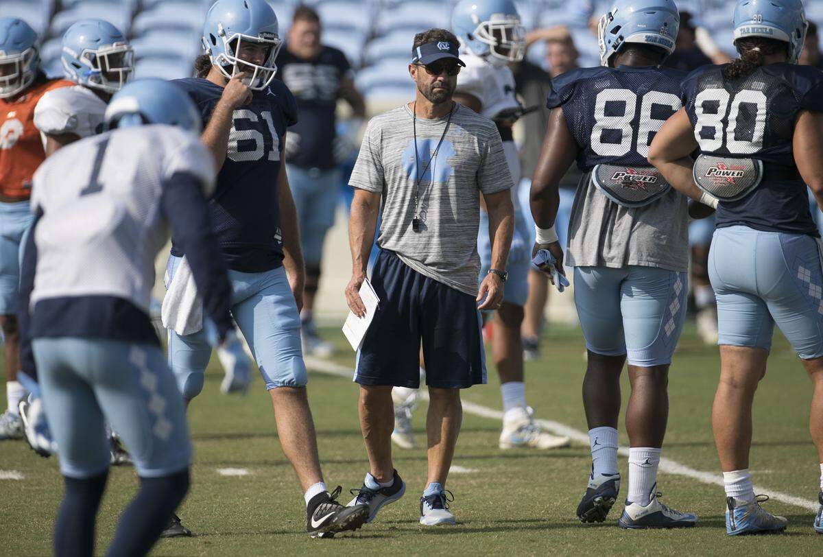 North Carolina coach Larry Fedora works with his players during practice on Tuesday, August 14, 2018 at Kenan Stadium in Chapel Hill, N.C.
