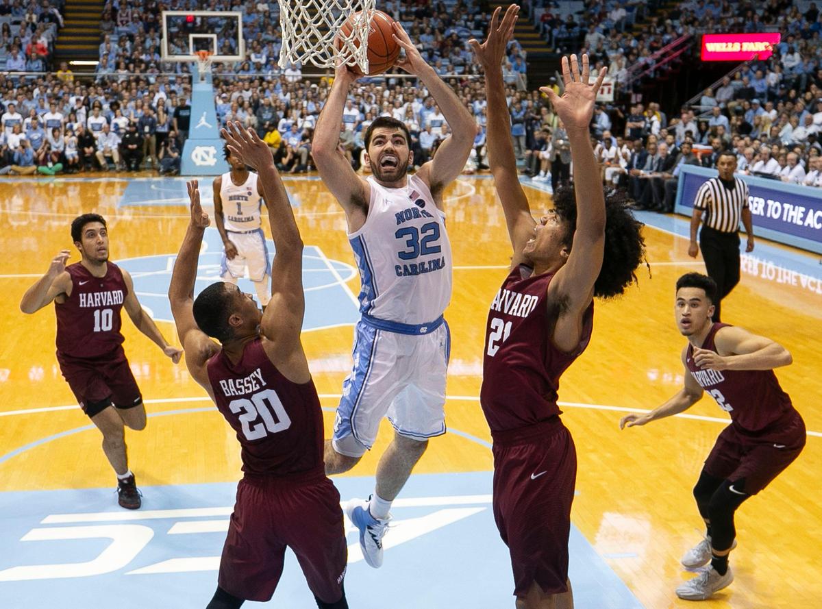 North Carolina’s Luke Maye (32) drives to the basket against Harvard’s Justin Bassey (20) and Mason Forbes (21) during the first half on Wednesday, January 2, 2019 at the Smith Center in Chapel Hill, N.C. Maye lead all scores with 14 points in the Tar Heels’ 77-57 victory.