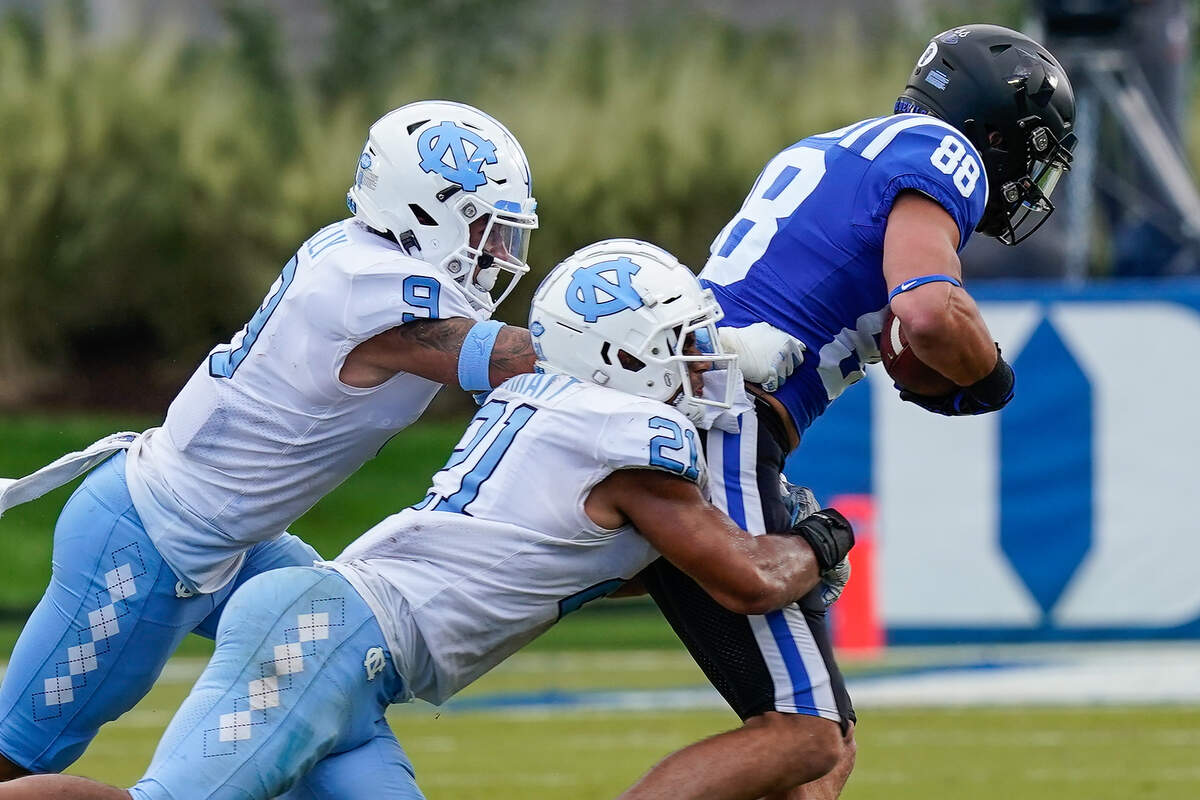 Duke Blue Devils tight end Jake Marwede (88) is tackled by North Carolina Tar Heels linebacker Chazz Surratt (21) and defensive back Cam’Ron Kelly (9) during the second half at Wallace Wade Stadium. 