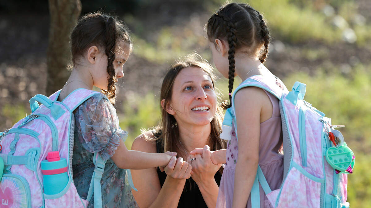 Nichole Dibenedetto talks with her daughters Ella, left, and Mia before they head into the first day of school at Green Magnet Elementary School in Raleigh, N.C., Tuesday, August 27, 2024.