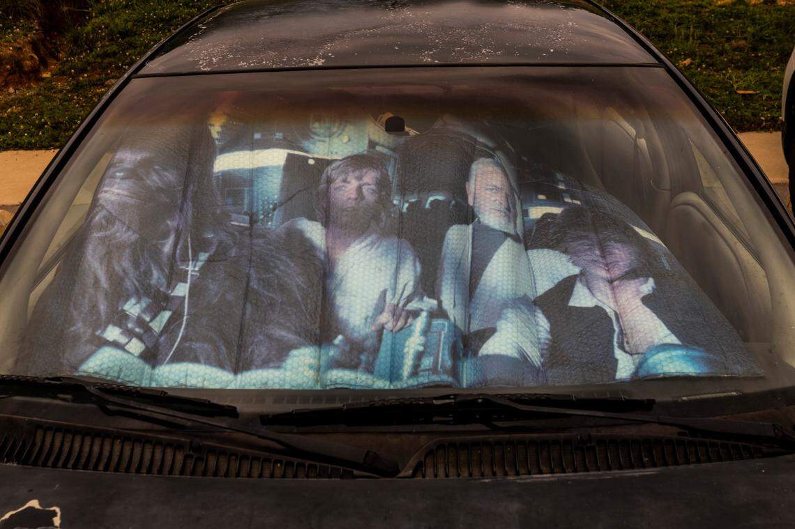 A faded Star Wars sun screen sits on the dash of Chapel Hill High history teacher Bill Melega’s 1996 Saturn.