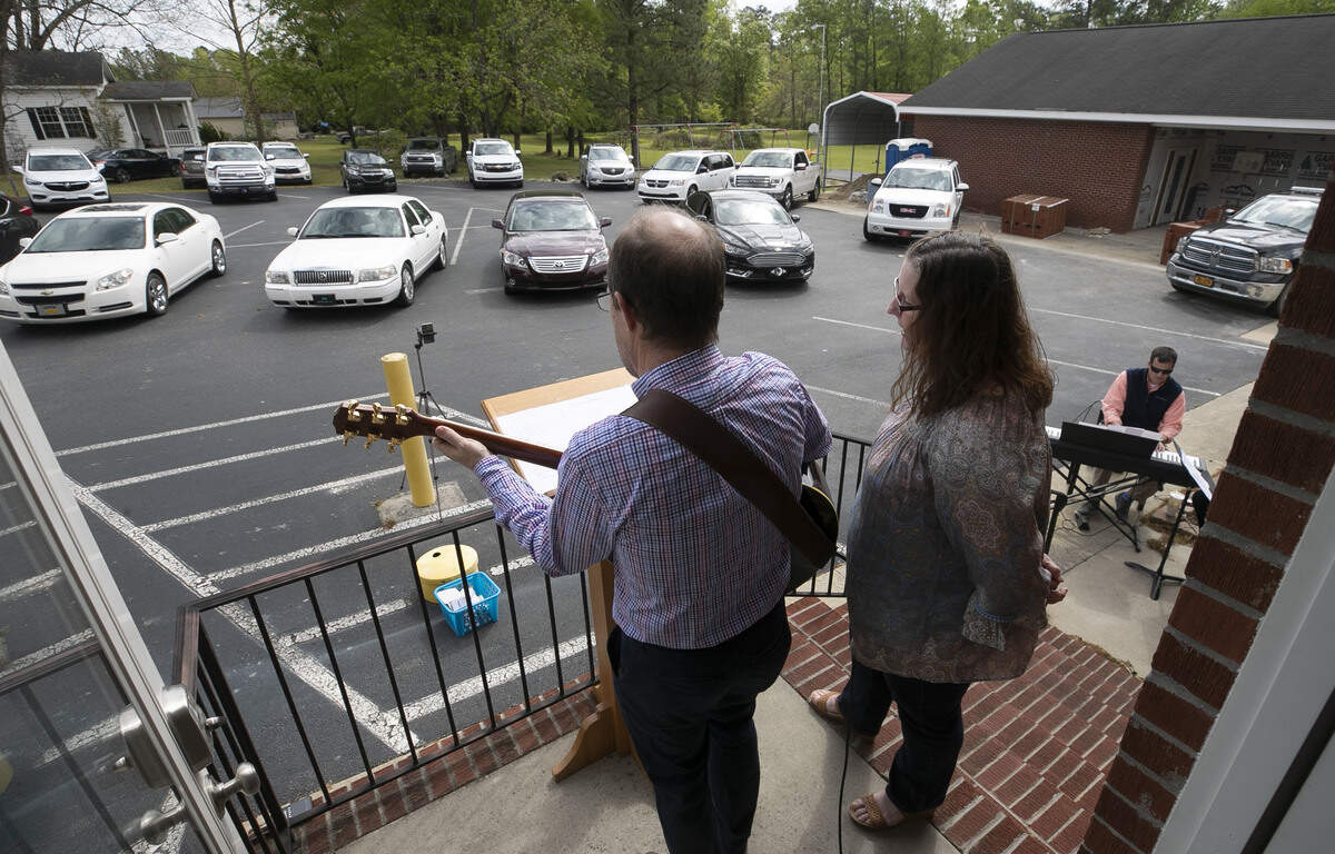 Ed and Glynis Meeker perform Easter worship service music during the drive-in service at Micro First Baptist Church in Micro, N.C. on Sunday, April 12, 2020.