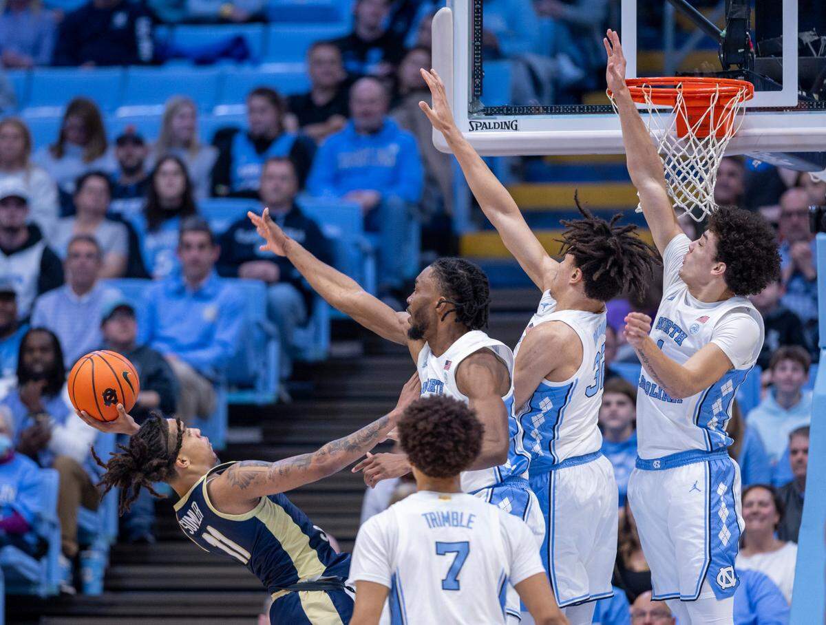 North Carolina’s Jae’Lyn Withers (24), James Okonkwo (32) and Zayden High (1) defend Charleston Southern’s A’lahn Sumler (11) in the second half on Friday, December 29, 2023 at the Smith Center in Chapel Hill, N.C.