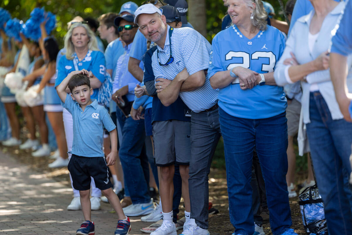 North Carolina fans line the sidewalk as they await the arrival of the football team on Saturday, October 7, 2023 at Kenan Stadium in Chapel Hill, N.C