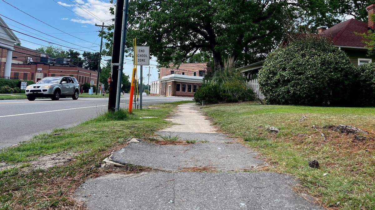 A crumbling sidewalk along Chapel Hill Road in central Durham, pictured August 4, 2022.