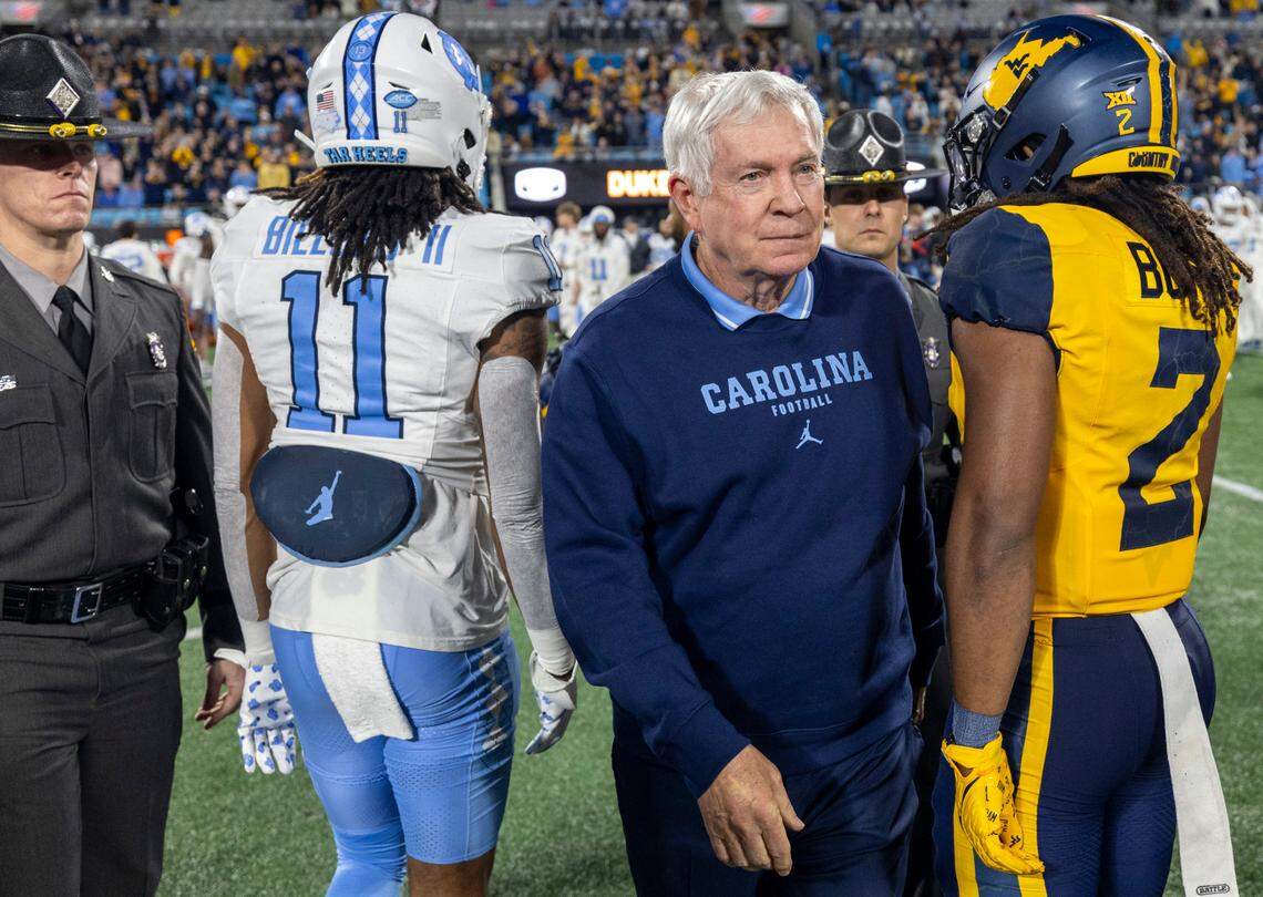 North Carolina coach Mack Brown walks to midfield to congratulate West Virginia coach Neal Brown following the Mountaineers’ 30-10 victory in the Duke’s Mayo Bowl on Wednesday, December 27, 2023 at Bank of America Stadium in Charlotte, N.C.