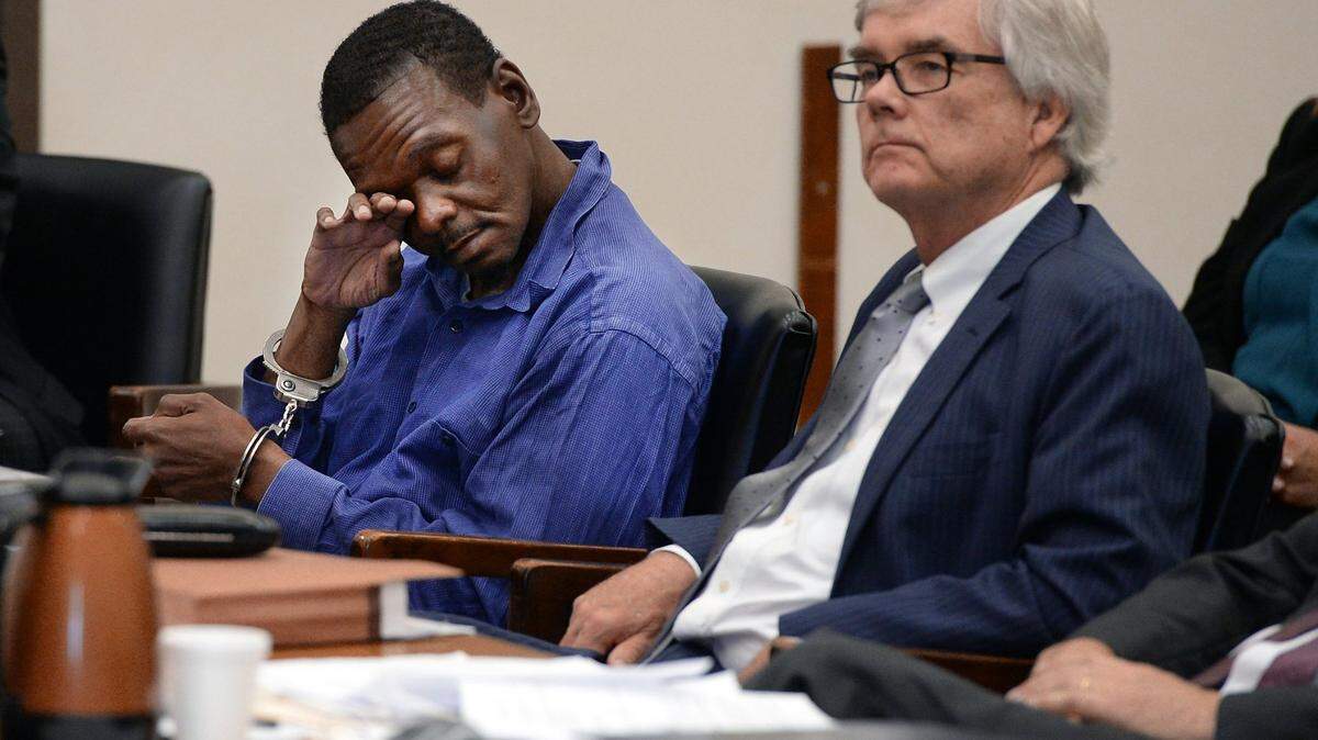 Henry McCollum wipes away tears as he sits next to his attorney, Richard Johnston, in the Robeson County courthouse in Lumberton, N.C. in 2014. McCollum and his brother Leon Brown spent three decades in prison for the rape and murder of a girl before DNA evidence implicated someone else. In 2021, a Raleigh jury awarded each of them $31 million in compensatory damages.