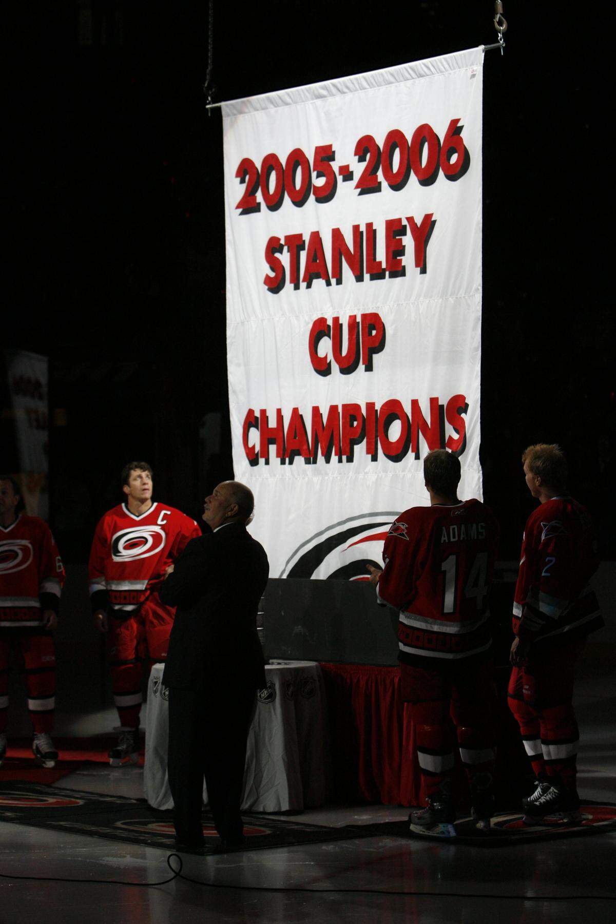 Carolina Hurricanes captain Rod Brind Amour, left, owner Peter Karmanos, center, Kevyn Adams and Glen Wesley watch as the Stanley Cup Banner is raised on Wednesday October 4, 2006 in the RBC Center.