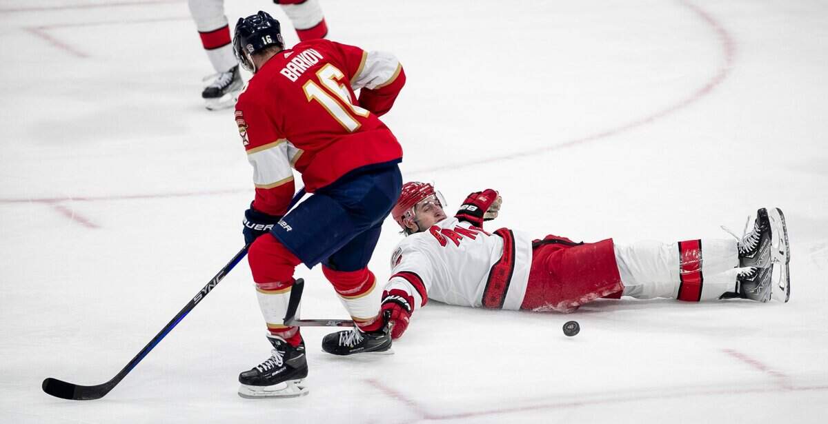 The Carolina Hurricanes Brady Skjei (76) hits the ice under the Florida Panthers Aleksander Barkov (16) in the second period during game 4 of the Eastern Conference Finals on Wednesday, May 24, 2023 at FLA Live Arena in Sunrise, Fla.