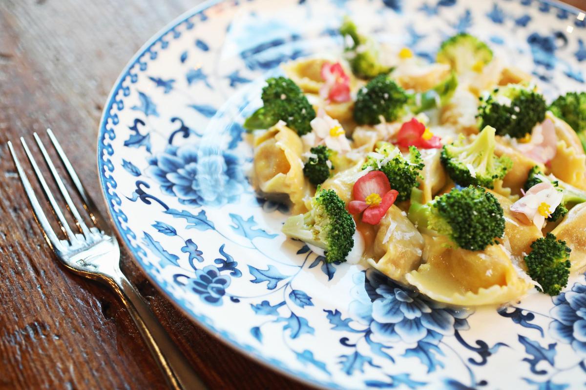 Oakleaf’s veal agnolotti is served with broccoli, parmigiano and topped with begonia flowers.