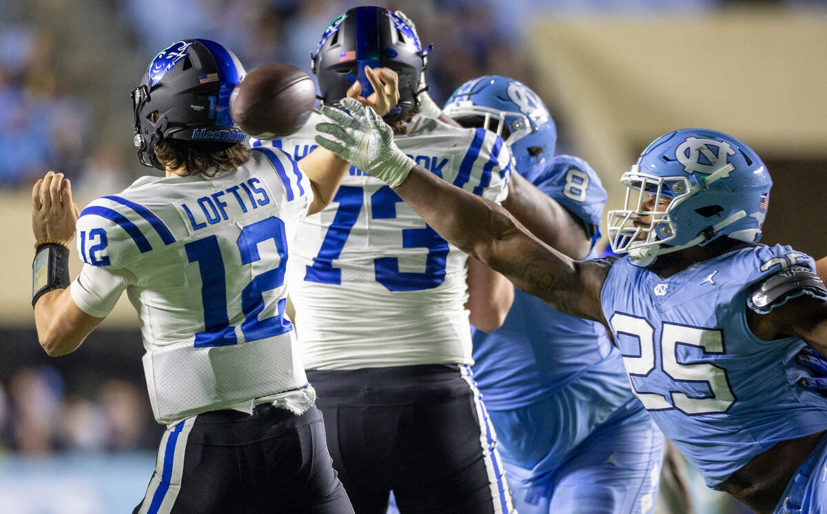 North Carolina’s Kaimon Rucker (25) pressures Duke quarterback Grayson Loftis (12) in the fourth quarter on Saturday, Nov. 11, 2023 at Kenan Stadium in Chapel Hill, N.C. The play was ruled an incomplete pass.