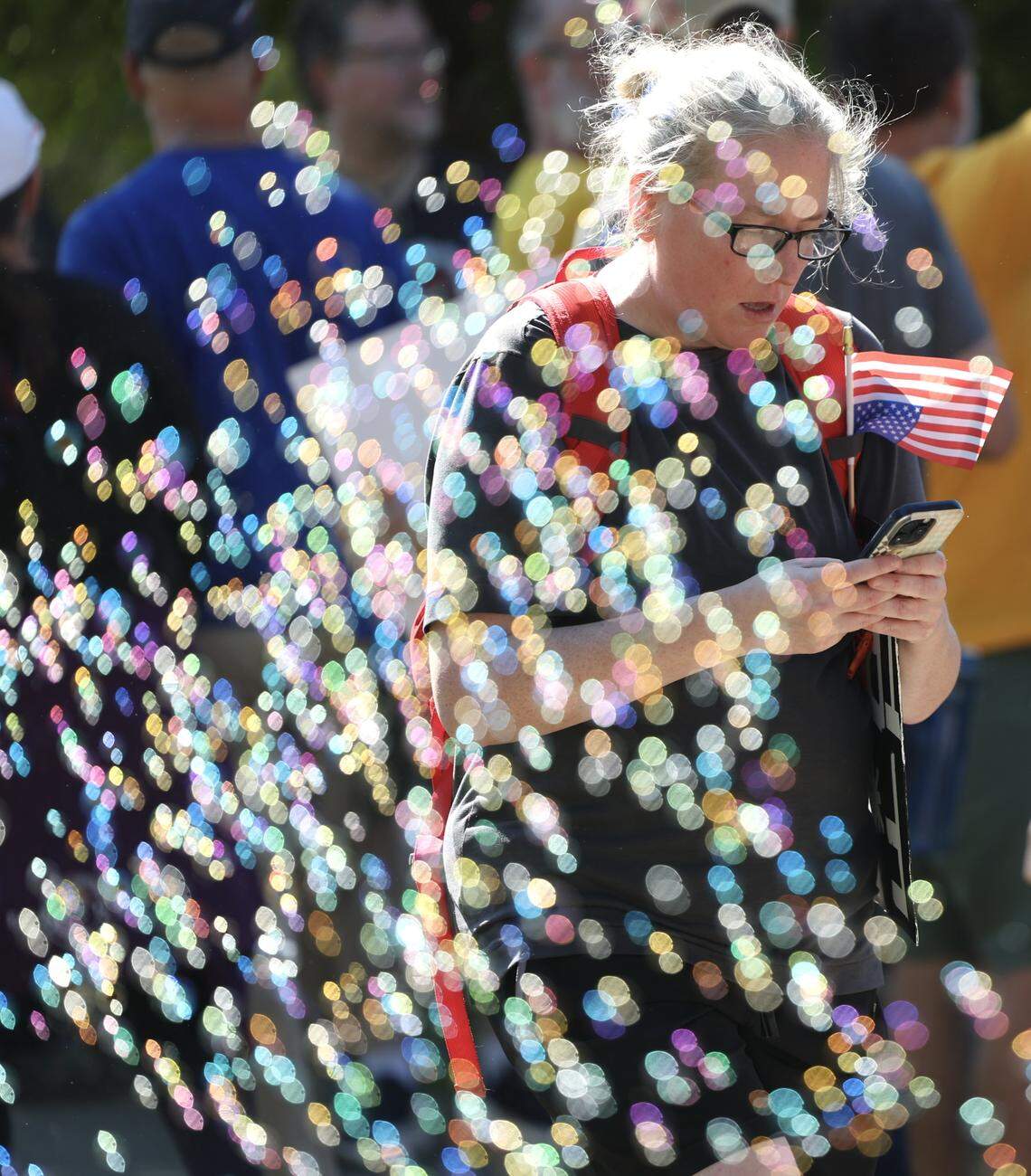 Rachael Wells walks through a sea of bubbles as she joins No Kings protesters on Capital Blvd. In Raleigh, Saturday, October 18, 2025.