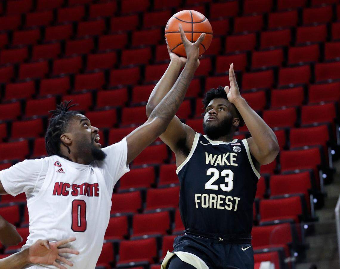 Wake Forest’s Isaiah Wilkins (23) as N.C. State’s D.J. Funderburk (0) defends during the first half of N.C. State’s game against Wake Forest at PNC Arena in Raleigh, N.C., Wednesday, January 27, 2021.