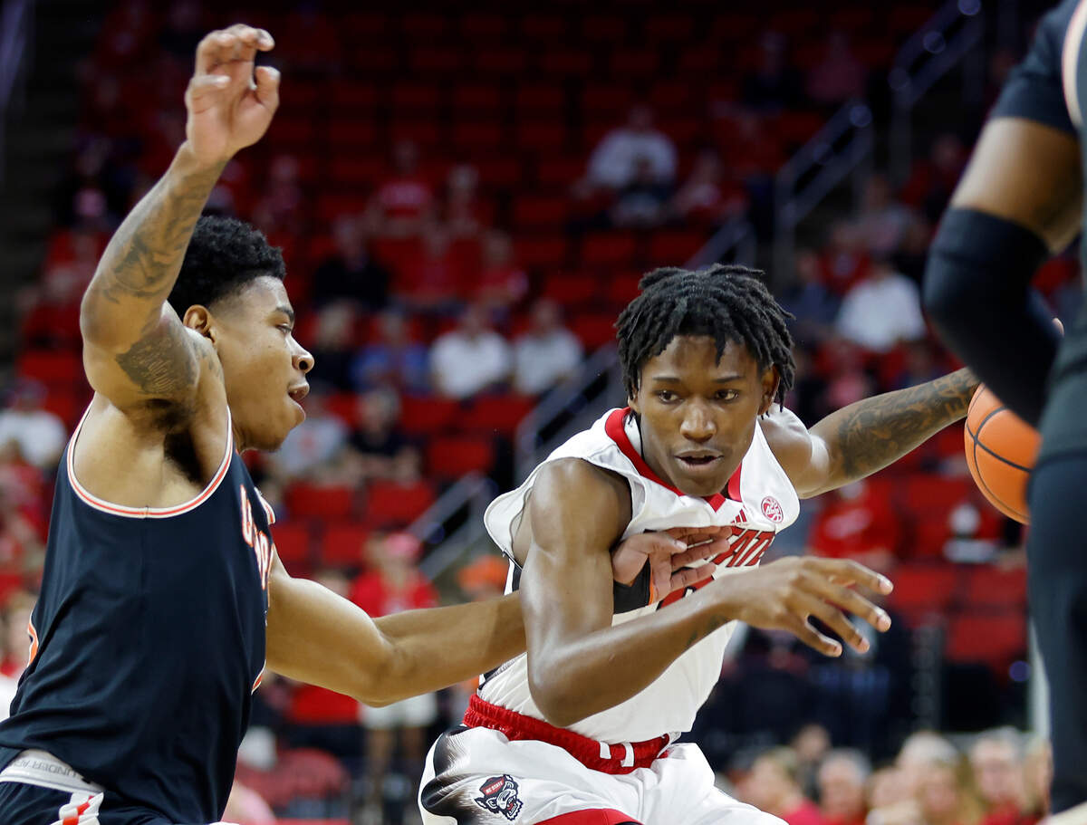 North Carolina State Wolfpack guard Terquavion Smith dribbles under pressure from Campbell Fighting Camels guard Ricky Clemons during the first half of a men’s basketball game at PNC Arena in Raleigh, N.C. on Friday, Nov. 11, 2022.