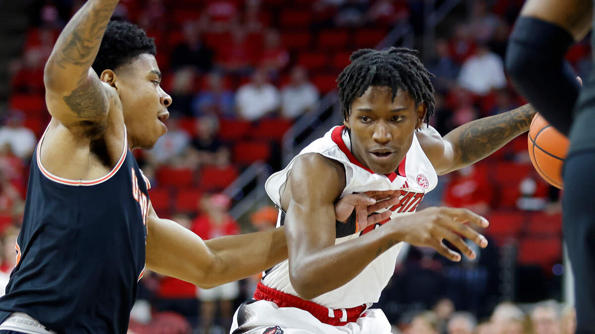 North Carolina State Wolfpack guard Terquavion Smith dribbles under pressure from Campbell Fighting Camels guard Ricky Clemons during the first half of a men’s basketball game at PNC Arena in Raleigh, N.C. on Friday, Nov. 11, 2022.