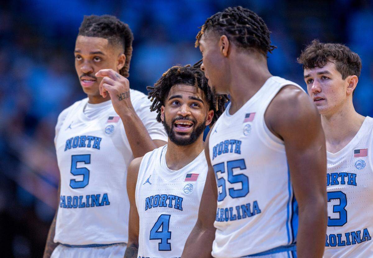 North Carolina’s R.J. Davis (4) chats with teammate Harrison Ingram (55) during a time out in the first half against Charleston Southern on Friday, December 29, 2023 at the Smith Center in Chapel Hill, N.C.