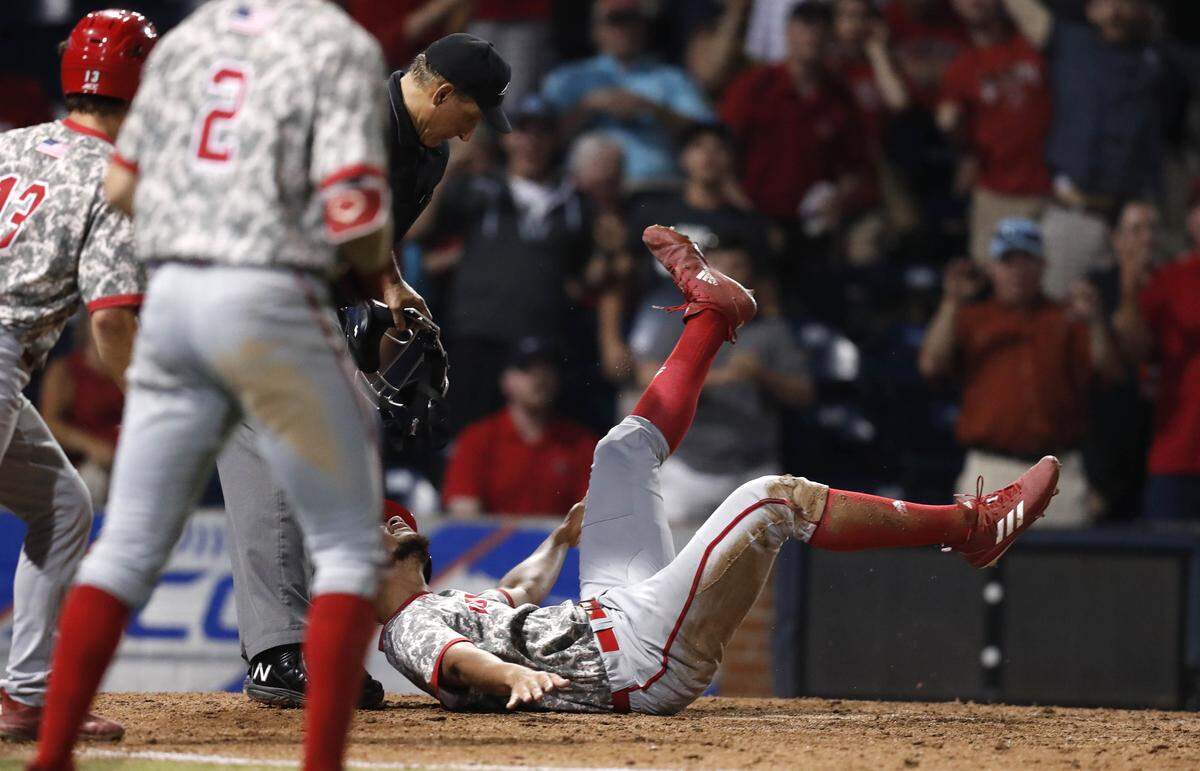 N.C. State’s David Harrison (10) looks up at the umpire after sliding into home in the ninth inning during N.C. State’s 6-5 victory over Wake Forest in the ACC Baseball Tournament at the Durham Bulls Athletic Park in Durham, N.C., Thursday, May 23, 2019. After initially being called out, on replay, Harrison was ruled safe.