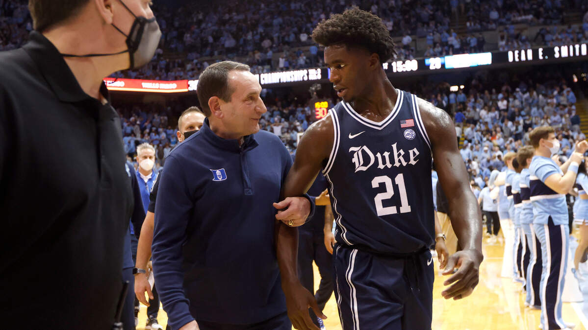 Duke head coach Mike Krzyzewski smiles as he talks to A.J. Griffin (21) as they walk off the court at halftime during the their game against UNC at the Smith Center in Chapel Hill, N.C., Saturday, Feb. 5, 2022.