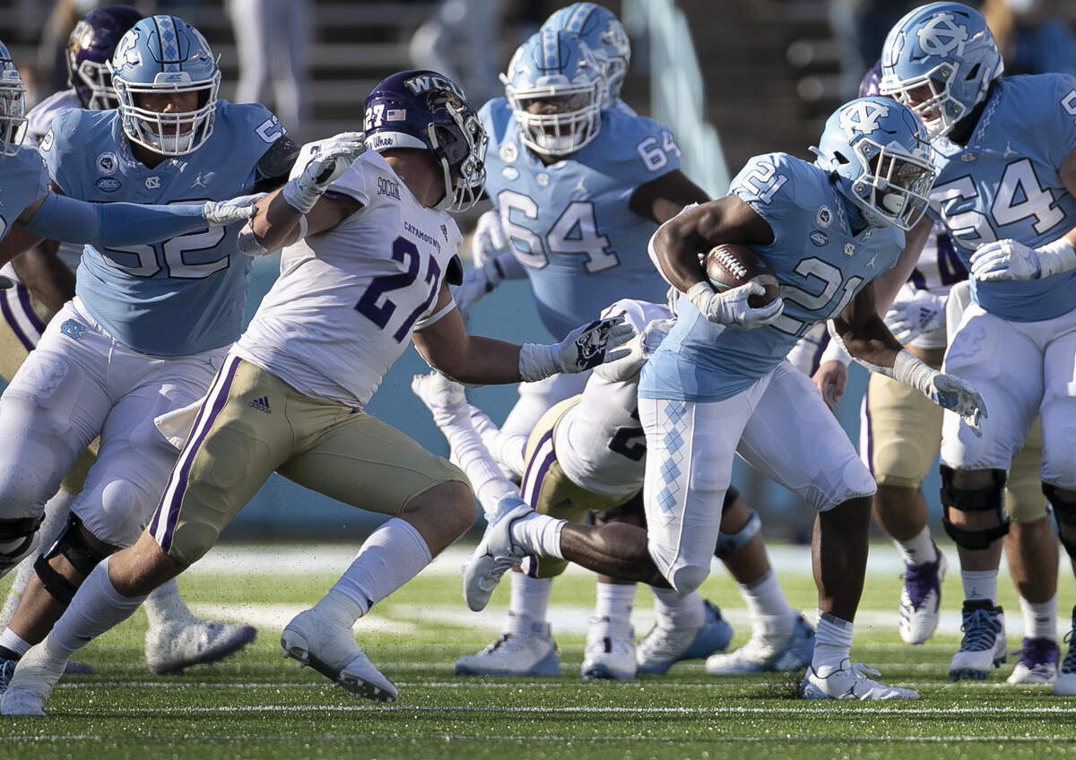 North Carolina’s Elijah Green (21) picks up 12 yards in the fourth quarter against Wester Carolina on Saturday, December 5, 2020 at Kenan Stadium in Chapel Hill, N.C.