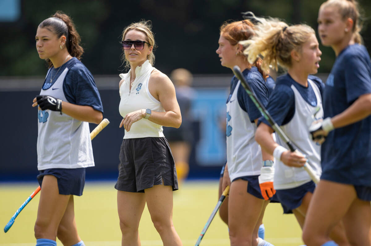 North Carolina field hockey coach Erin Matson watches her team as they warm up for their game against Iowa on Sunday, August 27, 2023 at Karen Shelton Stadium in Chapel Hill, N.C.