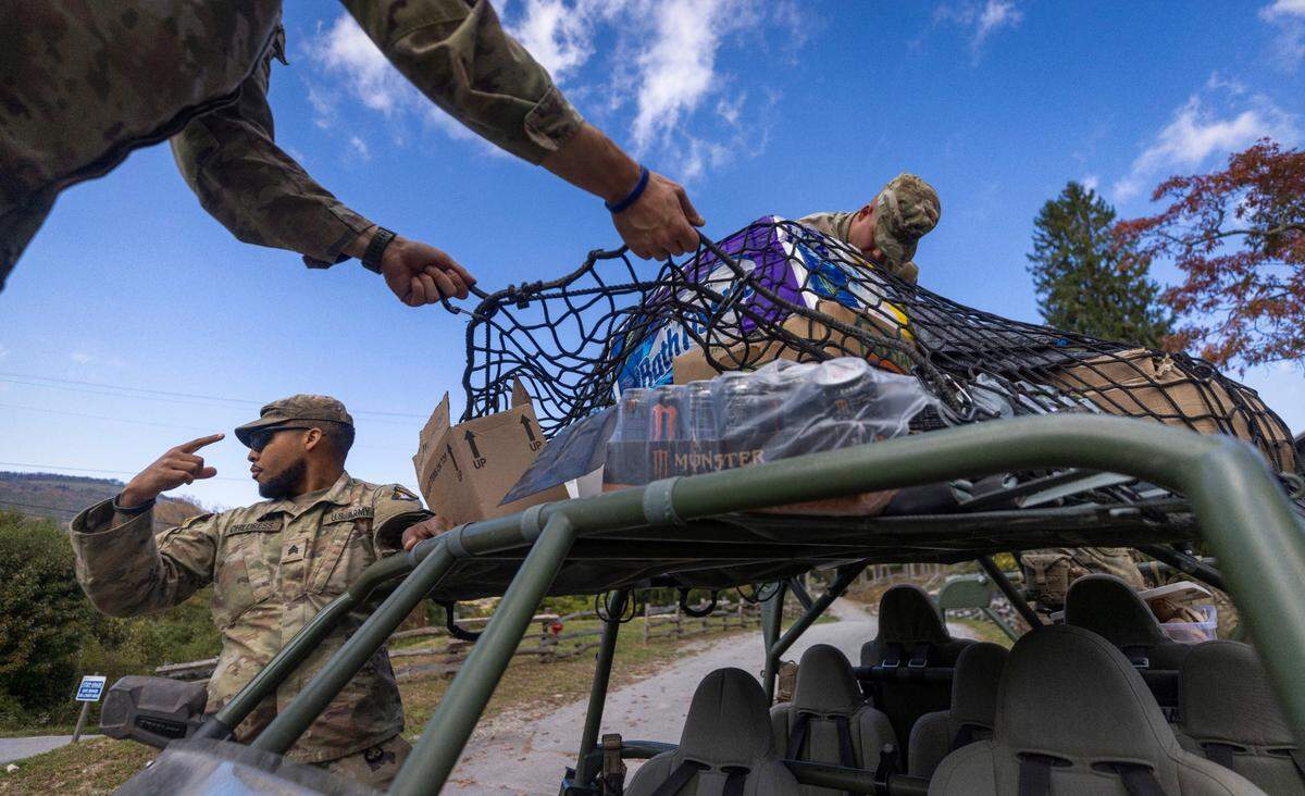 Soldiers with the 101st Airborne Division Air Assault, 2nd Brigade Combat Team, from Fort Campbell, Kentucky, use Infantry Squad Vehicles to deliver water, food, toiletries, and other aid to residents in the Soco Gap community in Maggie Valley on Tuesday, October. 8, 2024. The team has been using the Maggie Valley Pavilion and Town Hall as a distribution base for relief efforts in the town following Tropical Storm Helene.