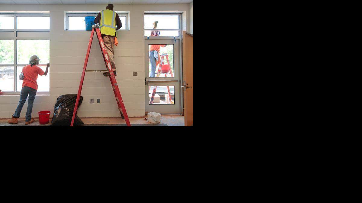 From left, Debora Hinton, Hadie Edmundson, Bonita Bobbitt work on Richland Creek Elementary School in Wake Forest. It is scheduled to open in August. 

