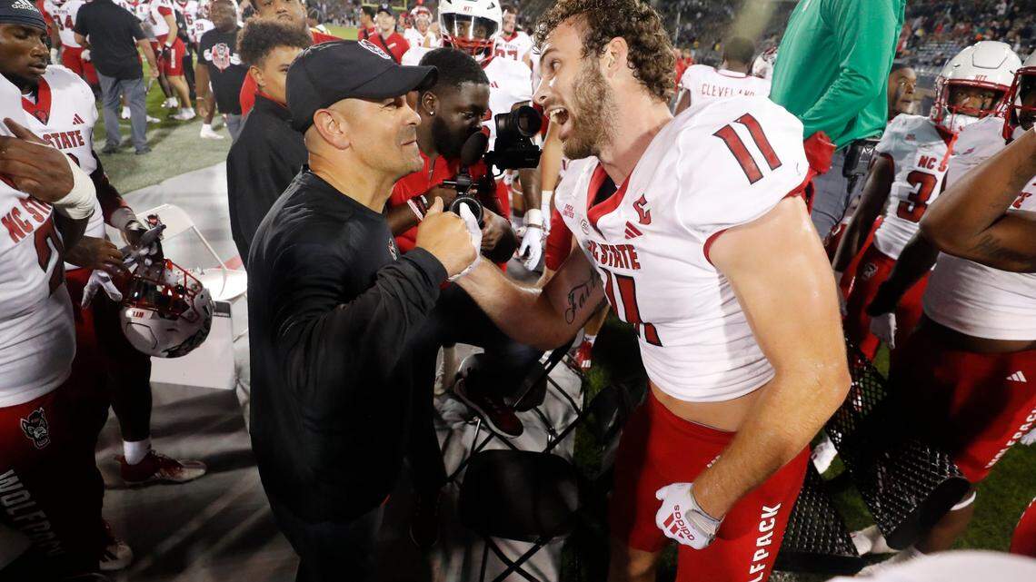 N.C. State defensive coordinator Tony Gibson congratulates Payton Wilson (11) after he intercepted the ball during the Wolfpack’s 24-14 victory over UConn at Rentschler Field in East Hartford, Conn. Thursday, August 31, 2023.