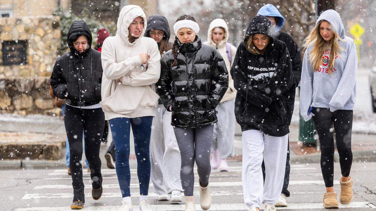 Pedestrians brave the freezing temperature as snow begins to fall at UNC-Chapel Hill on Wednesday, Feb. 19, 2024.