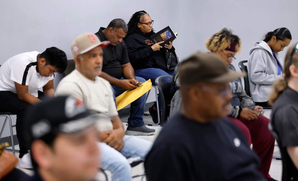 Christina Bethune of Knightdale reads her book ÒEvery Sweet Thing is BitterÓ as she waits to get her Real ID at the East Raleigh Division of Motor Vehicles office Friday, May, 30, 2025.