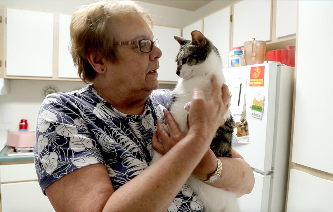Darlene Lavieri pets her cat Tucker  on May 19, 2018. Darlene is a senior who lives on a fixed income and enjoys the companionship of Tucker.  She gets some pet supplies from the AniMeals program sponsored and run by the Wake County SPCA.  The program delivers pet supplies and food to qualifying seniors so they don't have to choose between feeding themselves or their pet.