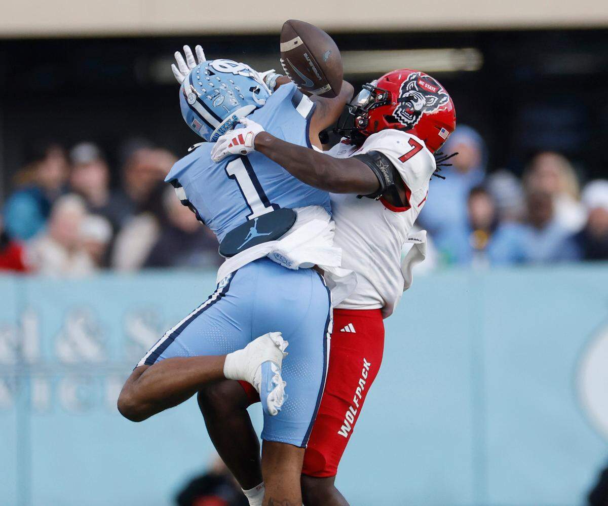 N.C. State safety Bishop Fitzgerald (7) breaks up a pass intended for North Carolina wide receiver Jordan Shipp (1) during the first half of N.C. State’s game against UNC at Kenan Stadium in Chapel Hill, N.C., Saturday, Nov. 30, 2024.