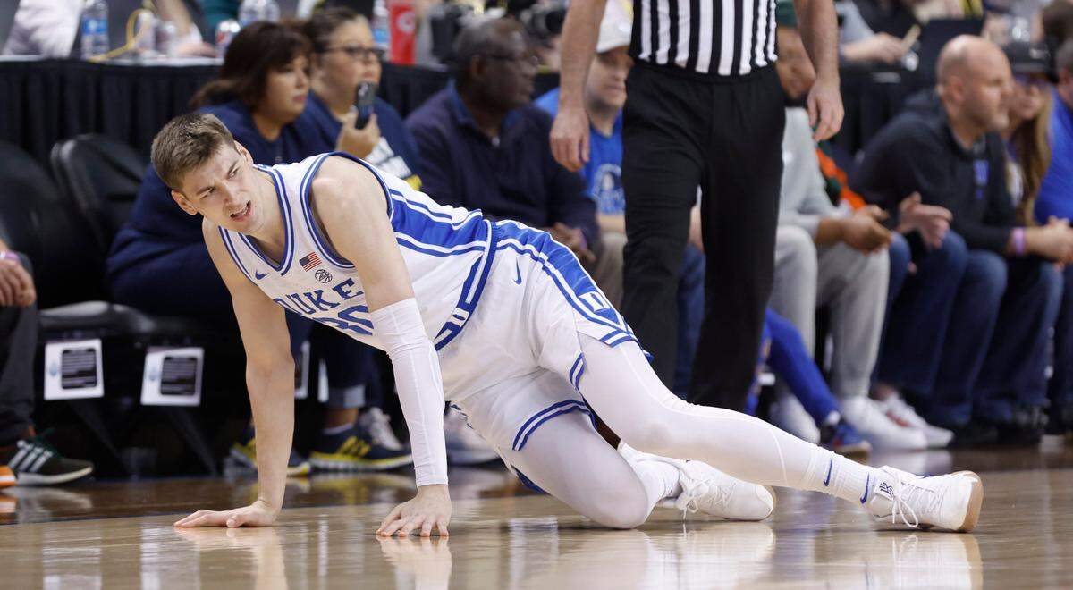 Duke’s Kyle Filipowski (30) tries to get up after being injured during Duke’s game against Pitt in the quarterfinals of the ACC Men’s Basketball Tournament in Greensboro, N.C., Thursday, March 9, 2023.