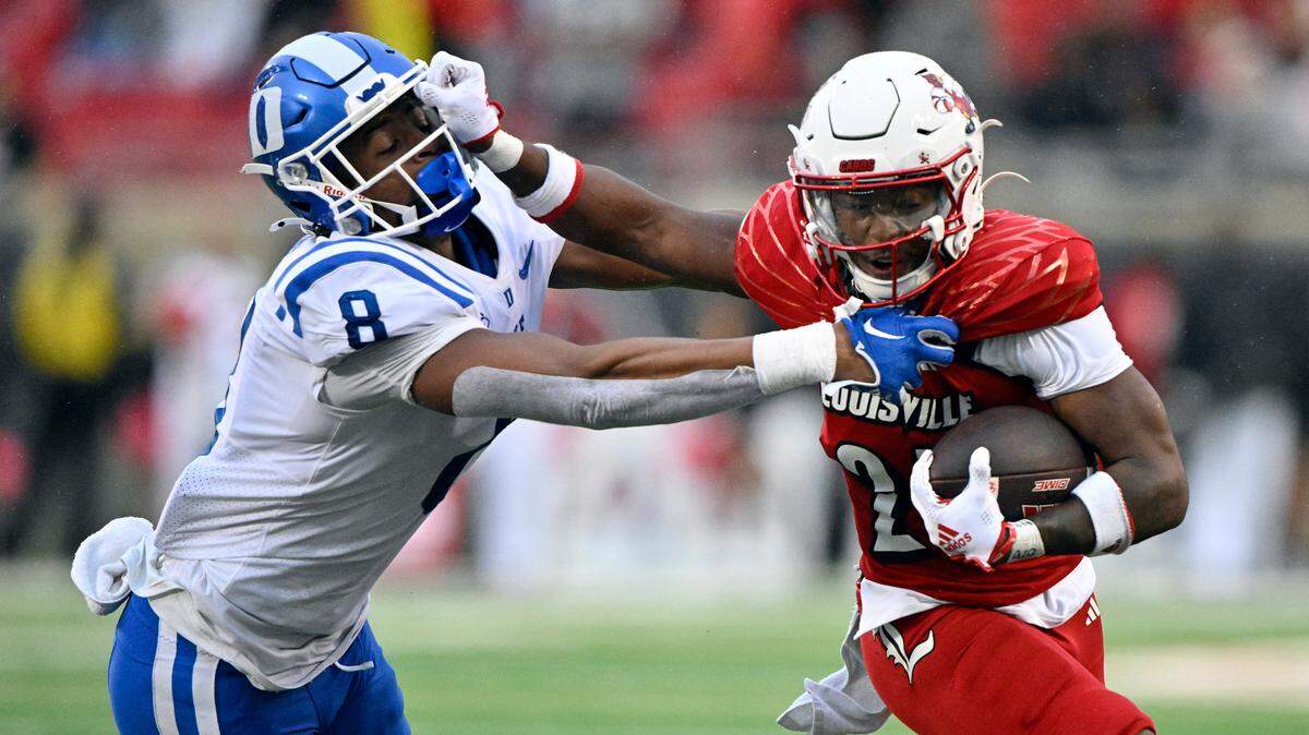 Louisville Cardinals running back Jawhar Jordan (25) runs the ball against Duke Blue Devils linebacker Dorian Mausi (8) during the second half at L&N Federal Credit Union Stadium. Louisville defeated Duke 23-0.