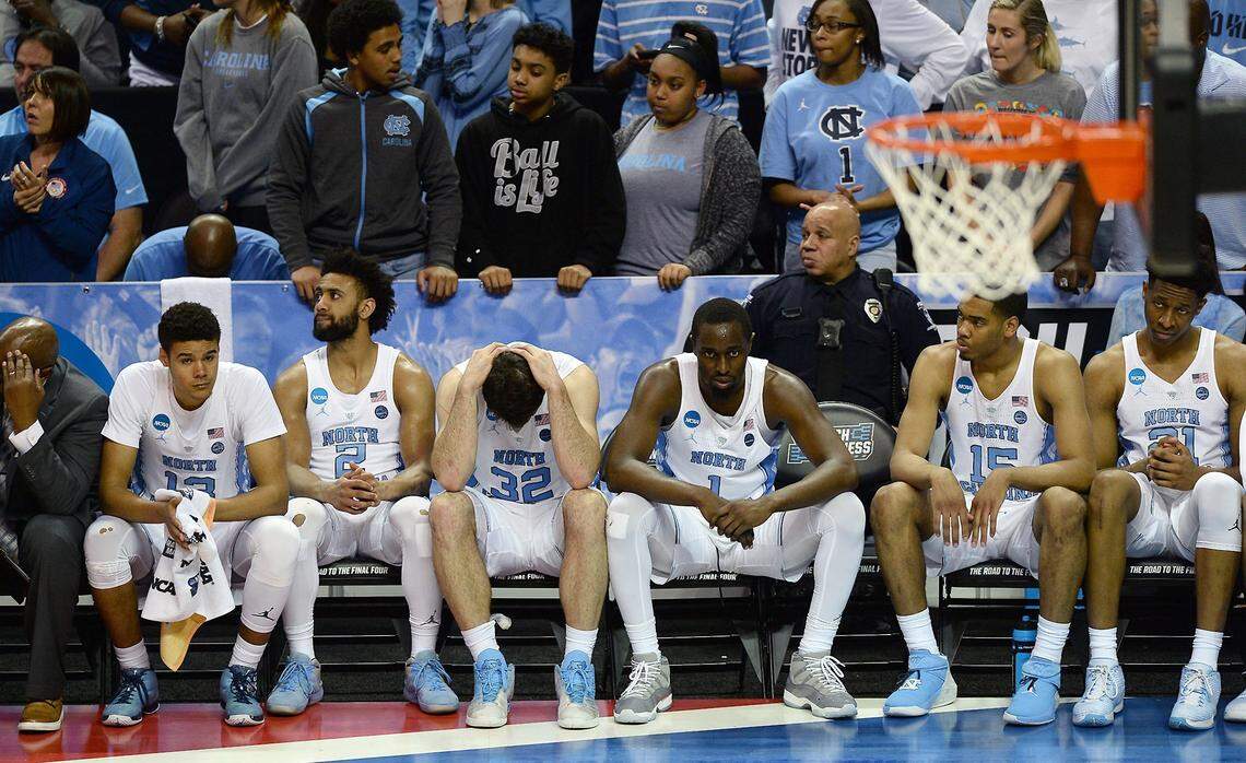UNC Tar Heels from left: Cameron Johnson, Joel Berry II, Luke Maye and Theo Pinson, Garrison Brooks and Sterling Manley sit on the team's bench in the closing seconds of action against Texas A&M during second round action in the NCAA Division I Men's Basketball Tournament at the Spectrum Center in Charlotte, NC on Sunday, March 18, 2018. Texas A&M defeated UNC 86-65.