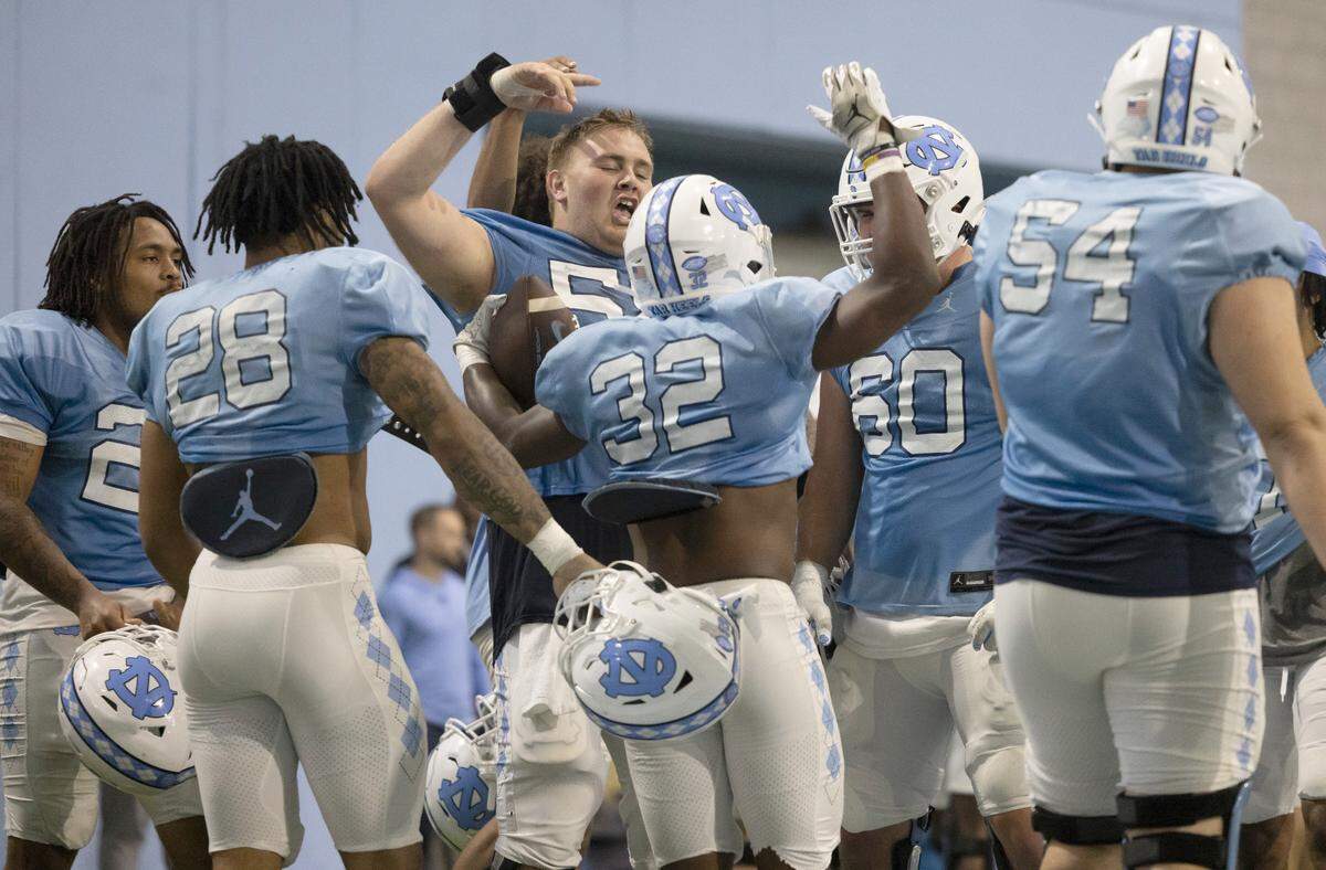 North Carolina’s Major Byrd (32) celebrates with teammate after scoring a touchdown during a scrimmage on Thursday, April 11, 2024 in Chapel Hill, N.C.