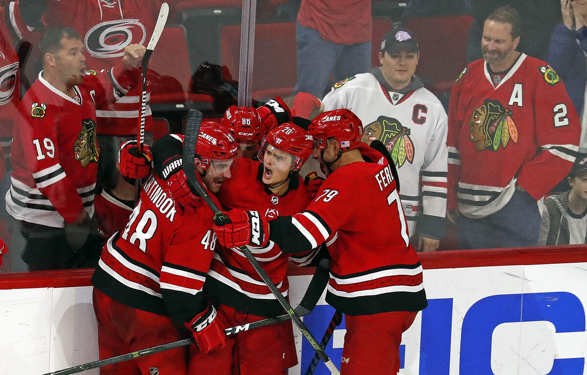 Carolina Hurricanes’ Sebastian Aho (20) celebrates his game winning overtime goal against the Chicago Blackhawks with teammates Teuvo Teravainen (86), Jordan Martinook (48), and Micheal Ferland (79) at an NHL hockey game, Monday, Nov. 12, 2018