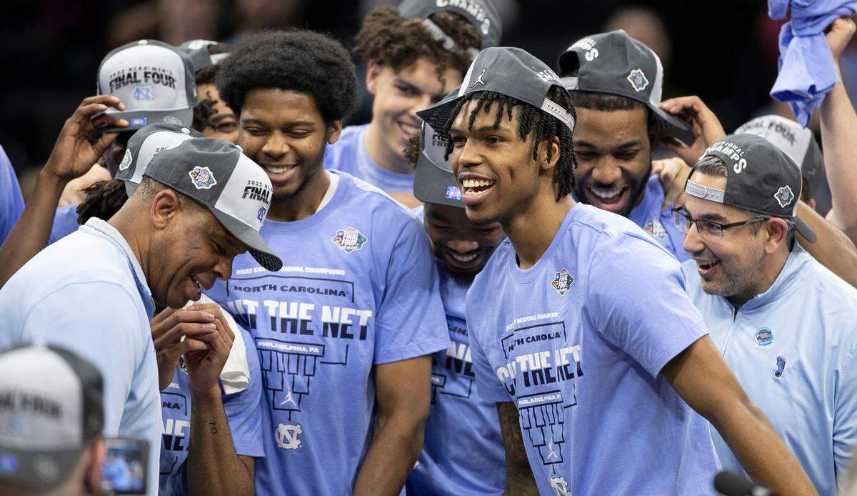 North Carolina’s Kerwin Walton (24) and Caleb Love (2) watch head catch Hubert Davis dance as they celebrate their victory over Saint Peter’s in the NCAA East Regional final on Sunday, March 27, 2022 at Wells Fargo Center in Philadelphia, Pa