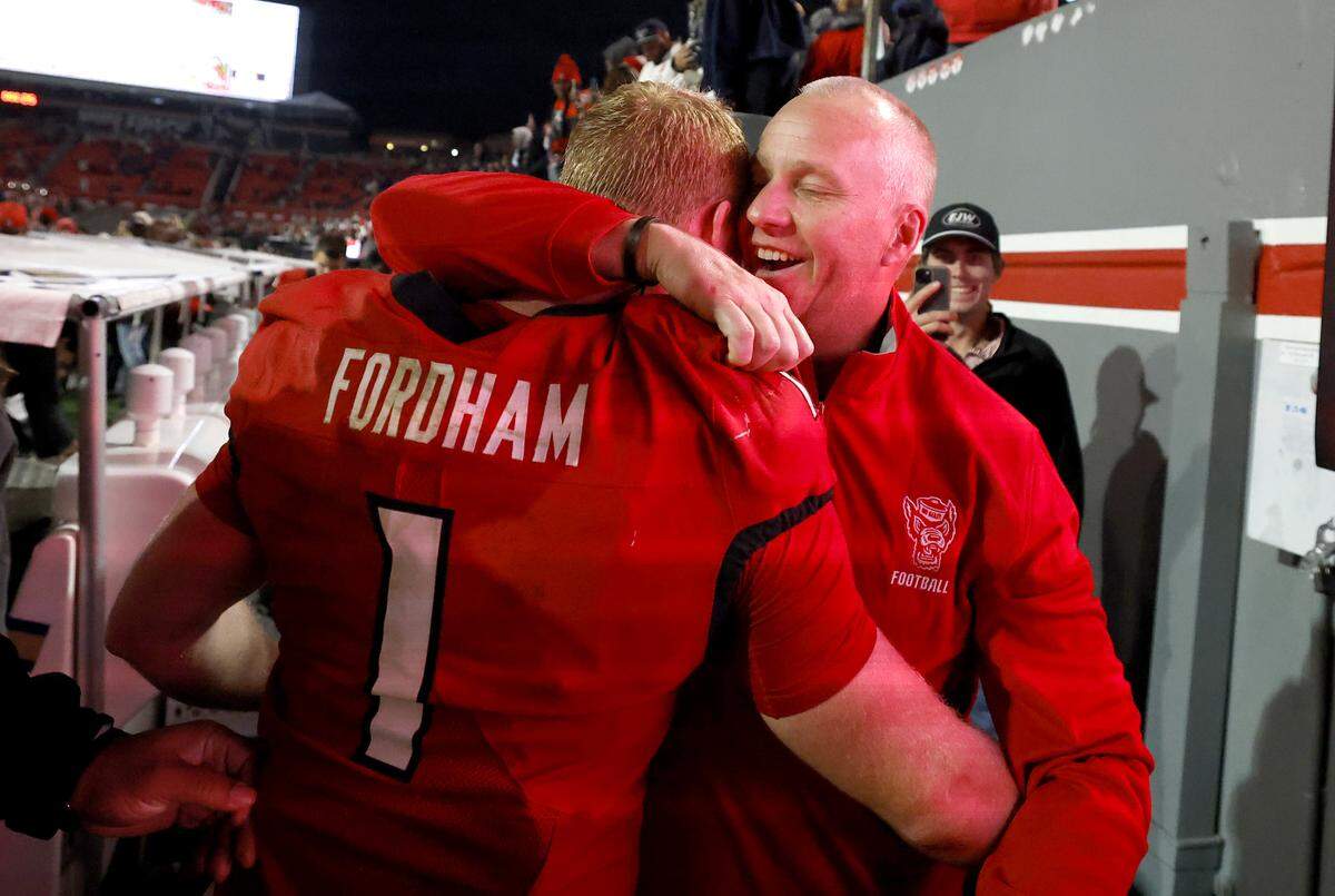 N.C. State head coach Dave Doeren hugs linebacker Caden Fordham (1) after N.C. State’s 48-36 victory over Georgia Tech at Carter-Finley Stadium in Raleigh, N.C., Saturday, Nov. 1, 2025.