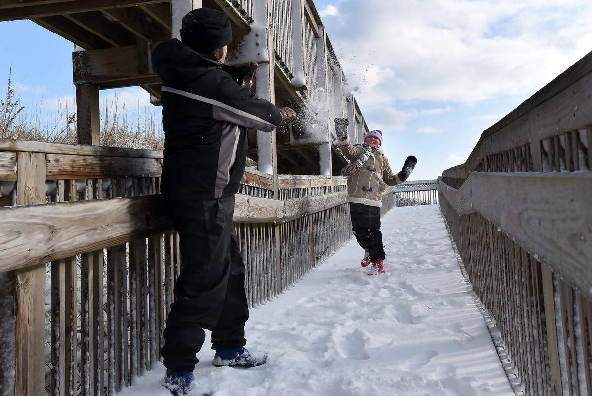 Danielle Vena and her daughter Autumn Sailor, 10 have impromptu snowball fight on a beach acres ramp in Nags Head on Jan.4, 2018. They were exploring the beach after an early morning winter storm dumped several inches of snow on the area.