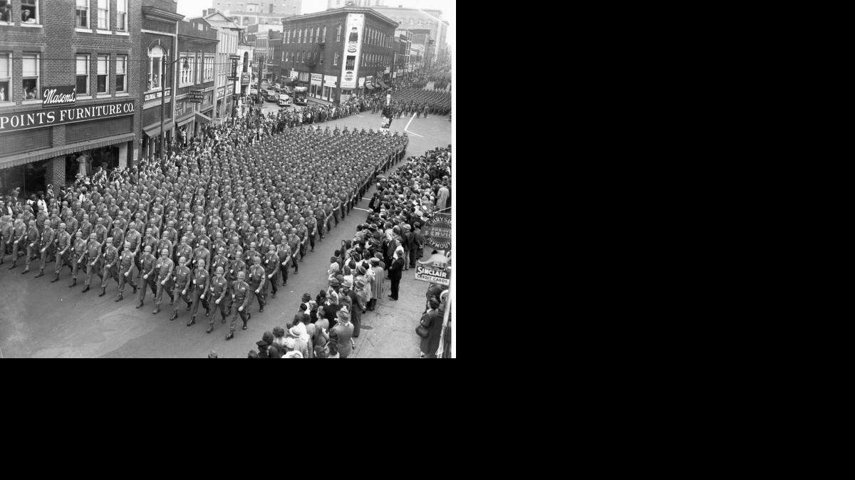 Troops from the 78th Infantry Division, stationed at Camp Butner, march through Five Points in Durham.
