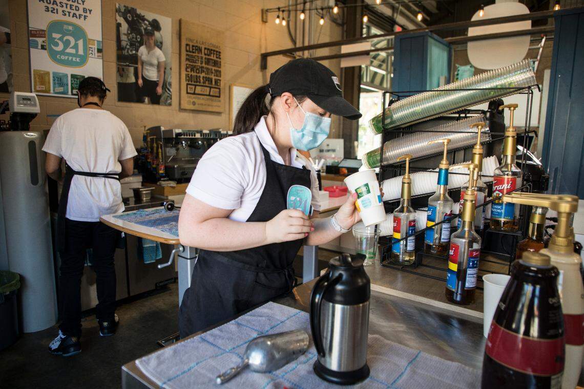 Barista Emma Wissink adds flavoring to a customer’s coffee order at 321 Coffee, located in the State Farmers Market in Raleigh, N.C., on Oct. 15, 2021.