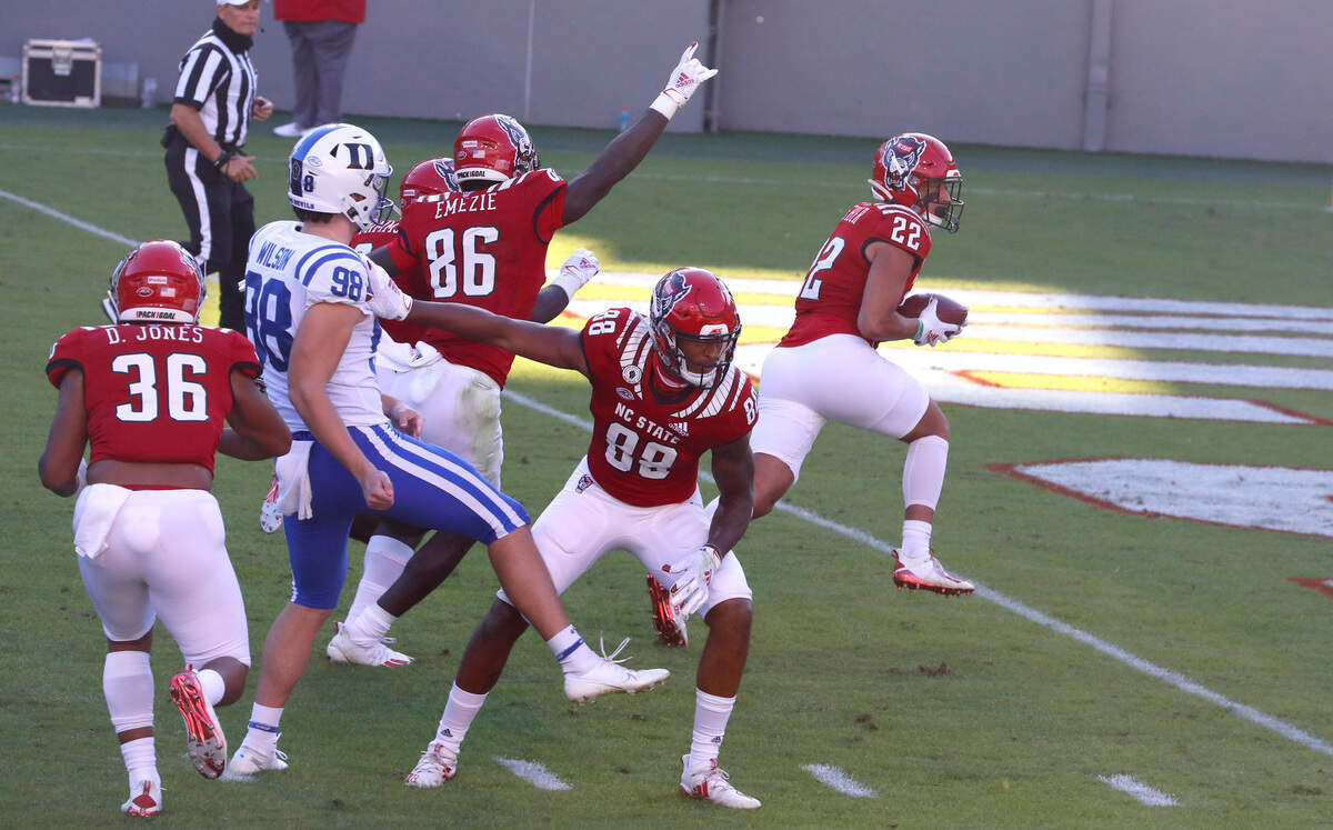 N.C. State’s Max Fisher (22) returns a blocked punt for a touchdown during the first half of N.C. State’s game against Duke at Carter-Finley Stadium in Raleigh, N.C., Saturday, Oct. 17, 2020.