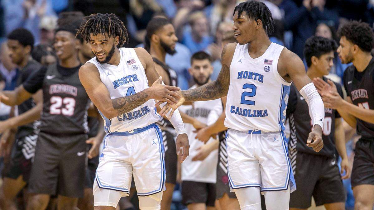 North Carolina’s Caleb Love (2) congratulates R.J. Davis (4) during a game against Brown on November 12, 2021 at the Smith Center. UNC will face Indiana in the ACC/Big Ten Challenge.