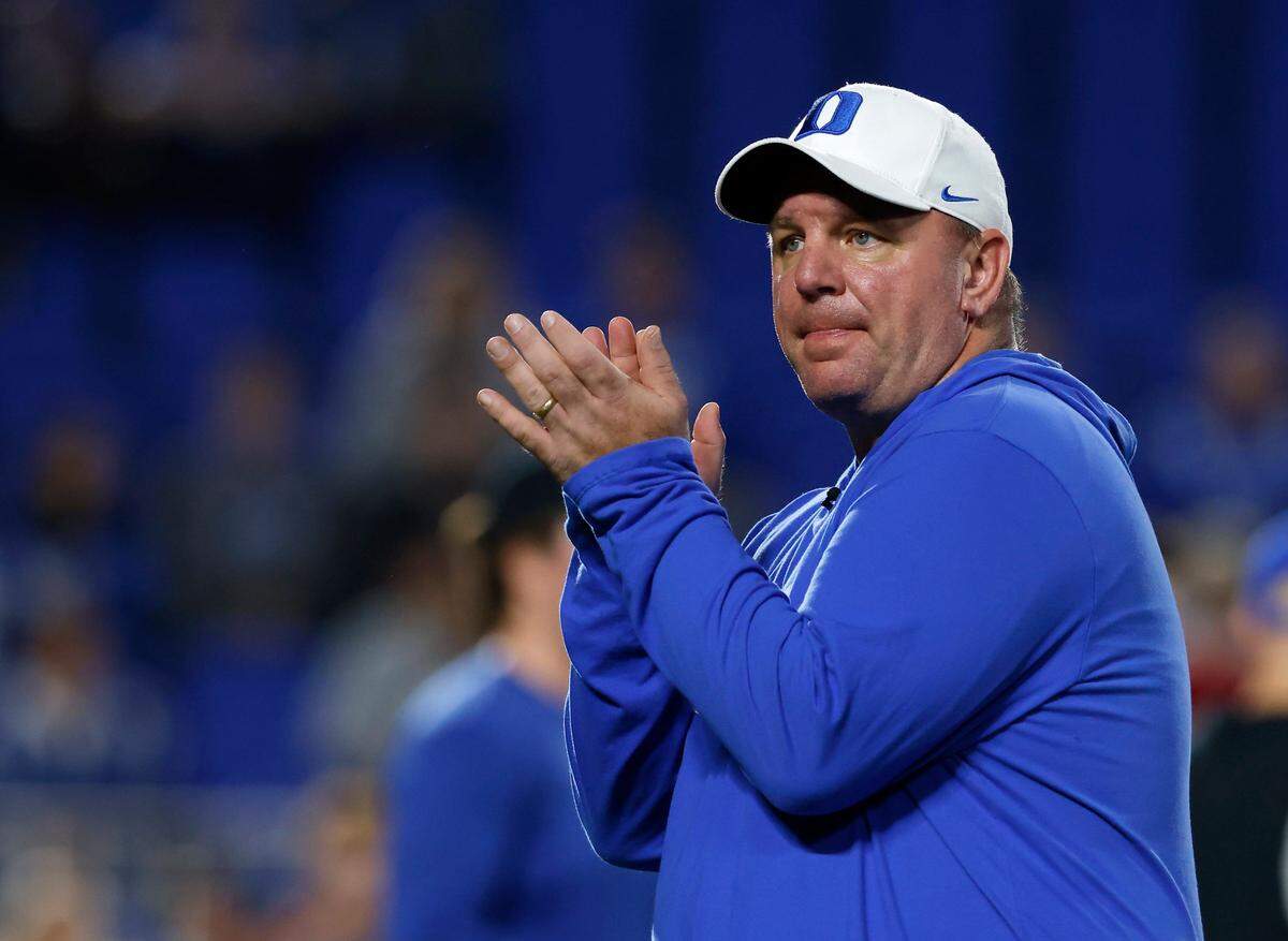 Duke head coach Mike Elko encourages his team during warmups prior to the Blue Devils’ game against N.C. State on Saturday, Oct. 14, 2023, at Wallace Wade Stadium in Durham, N.C.