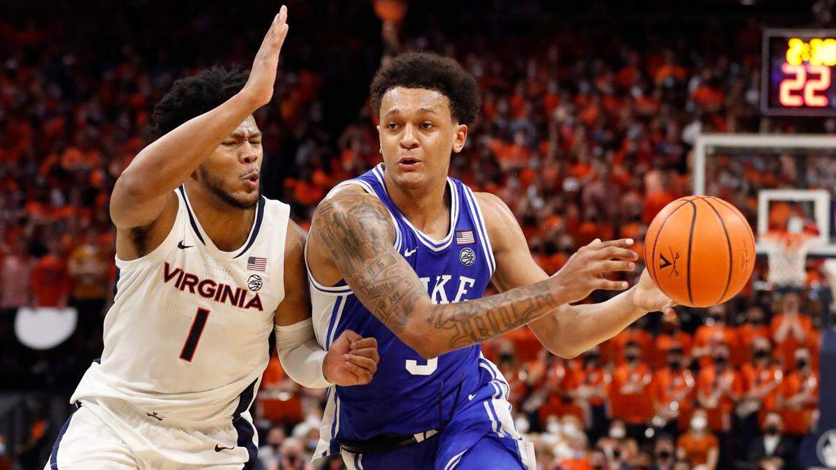 Dukes Paolo Banchero (5) drives as Virginia’s Jayden Gardner (1) defends during the first half of Dukes game against Virginia at John Paul Jones Arena in Charlottesville, VA, Wednesday, Feb. 23, 2022.