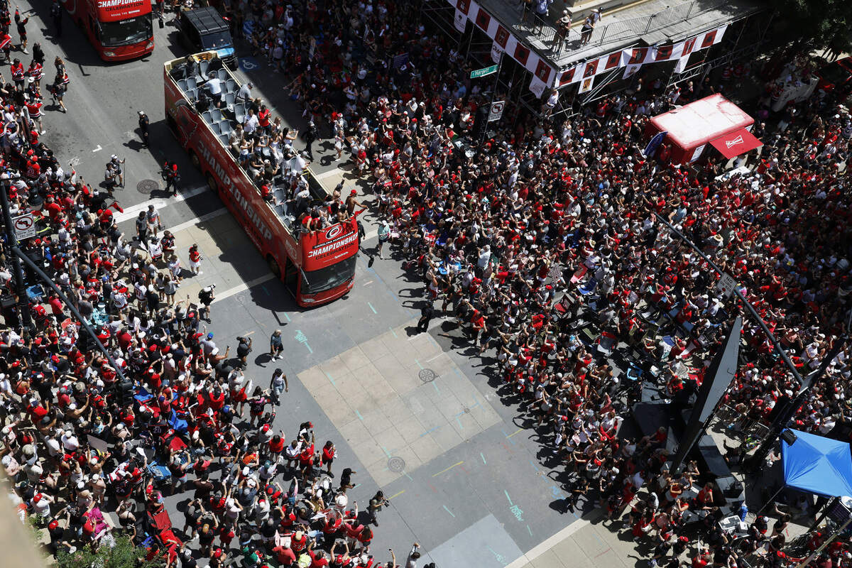 Buses carrying Carolina Hurricanes players and families along the parade route celebrating their Stanley Cup Championship.